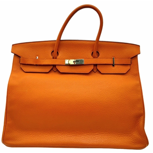 45 - A Hermes Togo Birkin Bag.
Highly in demand, this famed Orange Birkin is constructed with a spacious ... 