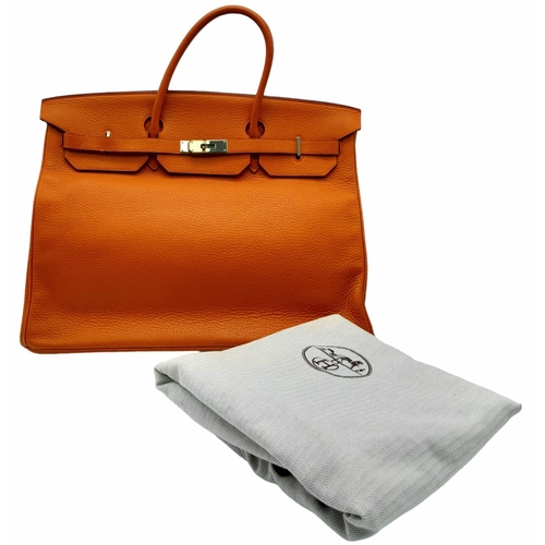 45 - A Hermes Togo Birkin Bag.
Highly in demand, this famed Orange Birkin is constructed with a spacious ... 