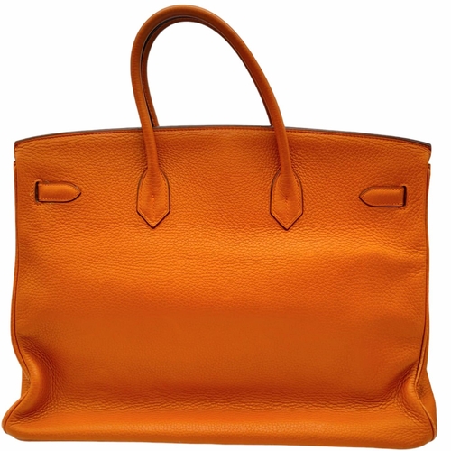 45 - A Hermes Togo Birkin Bag.
Highly in demand, this famed Orange Birkin is constructed with a spacious ... 