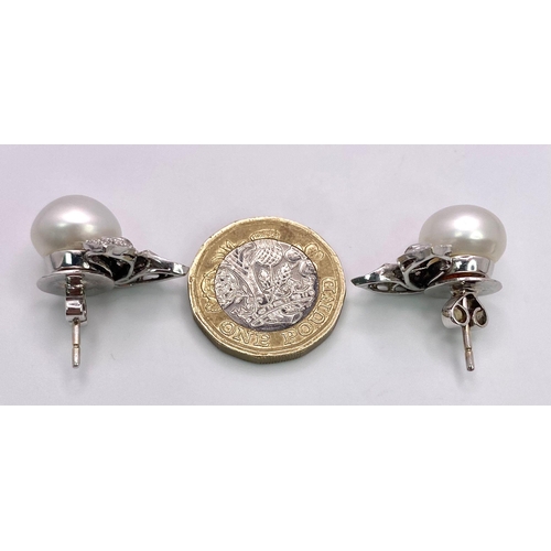 577 - A Pair of 14K White Gold, Diamond and South Sea Pearl Earrings. Large, rich, bulbous South Sea Pearl... 