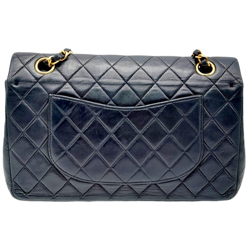 625 - The Chanel Black Classic Medium Lambskin Double Flap Bag is an iconic fashion accessory known for it... 