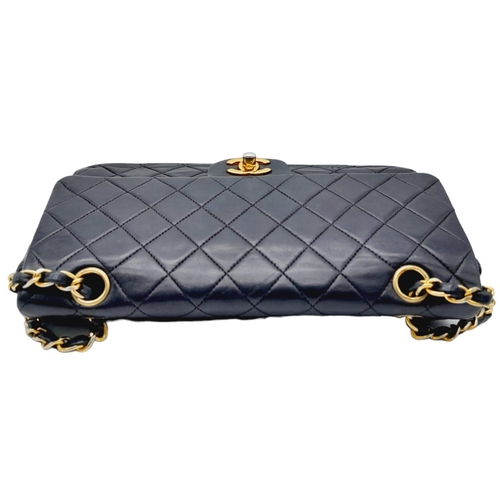 625 - The Chanel Black Classic Medium Lambskin Double Flap Bag is an iconic fashion accessory known for it... 