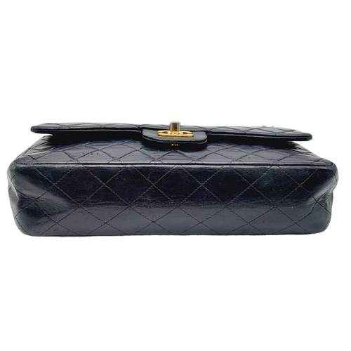 625 - The Chanel Black Classic Medium Lambskin Double Flap Bag is an iconic fashion accessory known for it... 