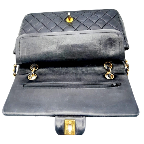 625 - The Chanel Black Classic Medium Lambskin Double Flap Bag is an iconic fashion accessory known for it... 