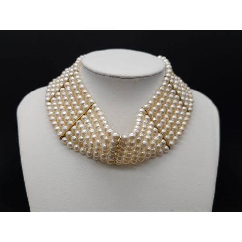 618 - A Seven Row and 18K Gold Choker Necklace. Gold bar separators and clasp. 33cm max length. Note - thi... 