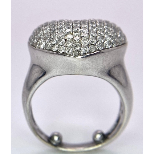 690 - A Designer 18K White Gold (DNA Marking) Diamond Heart Pave Ring. A large central diamond encrusted h... 