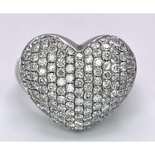 690 - A Designer 18K White Gold (DNA Marking) Diamond Heart Pave Ring. A large central diamond encrusted h... 