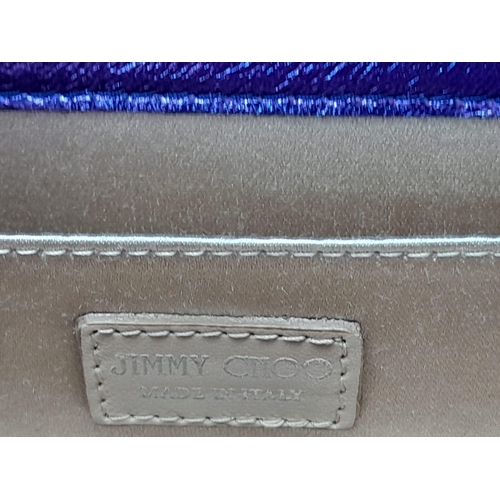 699 - The Jimmy Choo Sweetie Clutch in a luxurious shade of purple is a stylish accessory measuring 25cm i... 