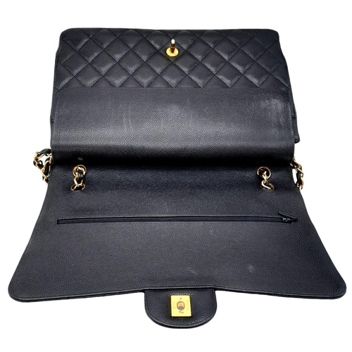 570 - Chanel The Large Classic Handbag exudes timeless elegance with its grained calfskin and gold-tone me... 