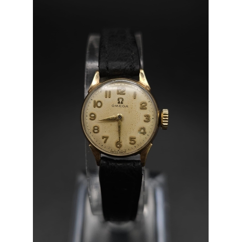 596 - A Vintage Omega 9K Gold Ladies Watch. Black leather strap. 9K gold case - 19mm. White dial. In worki... 