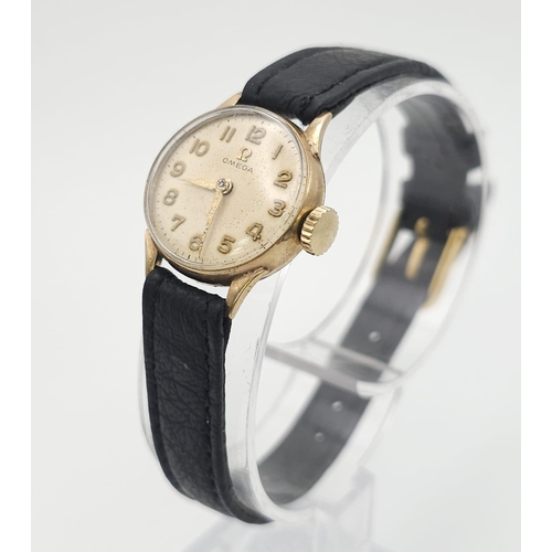 596 - A Vintage Omega 9K Gold Ladies Watch. Black leather strap. 9K gold case - 19mm. White dial. In worki... 