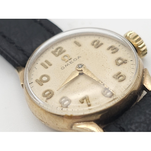 596 - A Vintage Omega 9K Gold Ladies Watch. Black leather strap. 9K gold case - 19mm. White dial. In worki... 