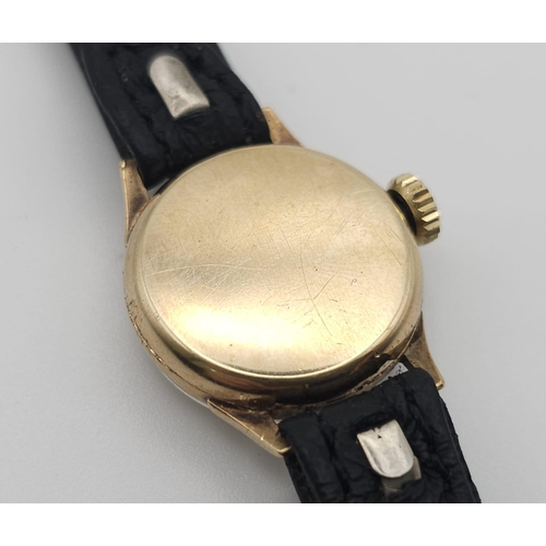 596 - A Vintage Omega 9K Gold Ladies Watch. Black leather strap. 9K gold case - 19mm. White dial. In worki... 