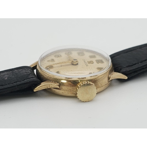 596 - A Vintage Omega 9K Gold Ladies Watch. Black leather strap. 9K gold case - 19mm. White dial. In worki... 