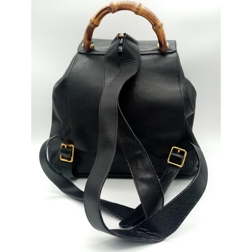 597 - The Gucci Vintage Bamboo Leather Backpack in sleek black leather exudes timeless elegance. With a wi... 