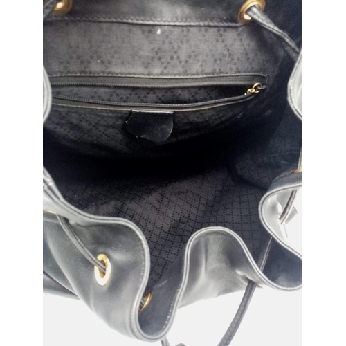 597 - The Gucci Vintage Bamboo Leather Backpack in sleek black leather exudes timeless elegance. With a wi... 