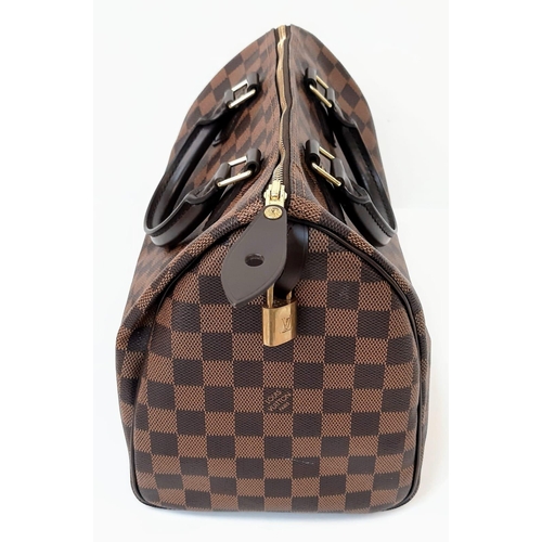 645 - The Louis Vuitton Speedy 35 in Damier Ebene canvas is a timeless and elegant handbag, measuring 31cm... 