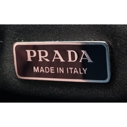 659 - A dazzling Prada Handbag with attached Key Chain.
Black based to ensure the sparkle never dies, this... 