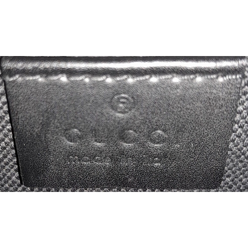 666 - A Black Gucci Cross-Over Satchel.
With a quality red & navy adjustable strap, this satchel can be wo... 