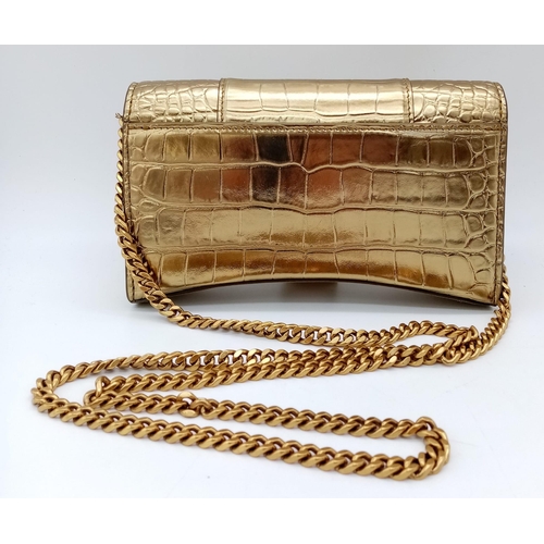 713 - Introducing the Balenciaga Hourglass Bag in a stunning gold hue – a true embodiment of luxury and co... 