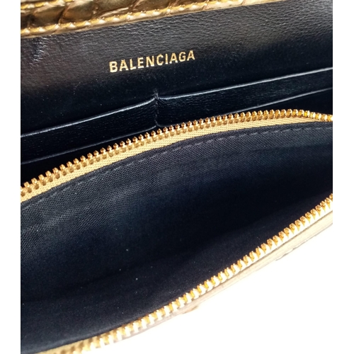 713 - Introducing the Balenciaga Hourglass Bag in a stunning gold hue – a true embodiment of luxury and co... 