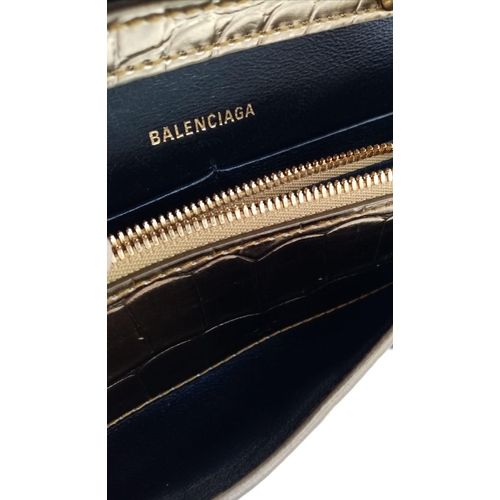 713 - Introducing the Balenciaga Hourglass Bag in a stunning gold hue – a true embodiment of luxury and co... 