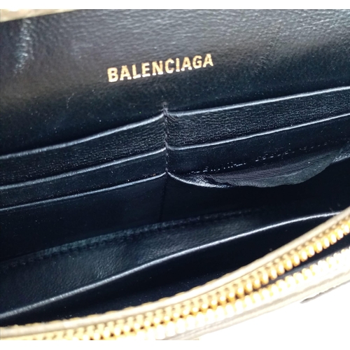 713 - Introducing the Balenciaga Hourglass Bag in a stunning gold hue – a true embodiment of luxury and co... 