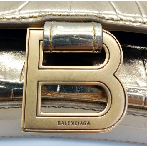 713 - Introducing the Balenciaga Hourglass Bag in a stunning gold hue – a true embodiment of luxury and co... 