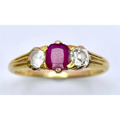 952 - An Antique 18K Yellow Gold Ruby and Diamond Ring. Central ruby (possibly Burmese) with a round cut d... 