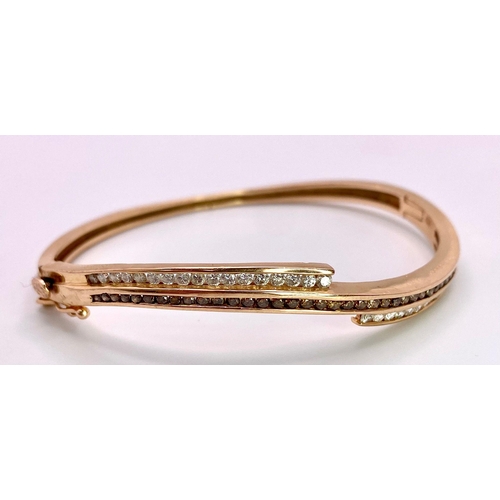 959 - A 14K Rose Gold, White and Cognac Brown Diamond Wave Bangle. Over 60 round cut diamonds ride on a wa... 