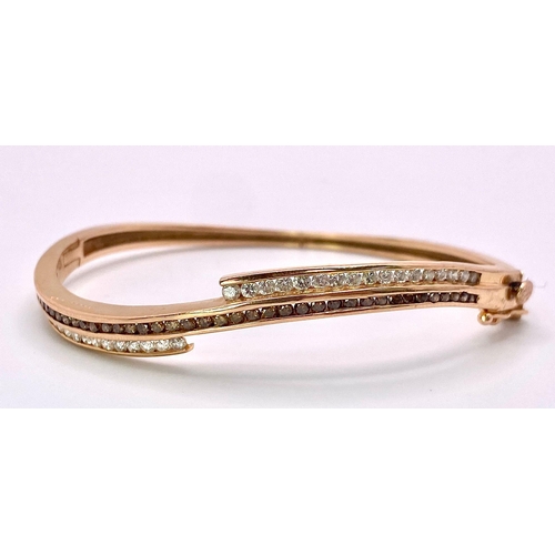 959 - A 14K Rose Gold, White and Cognac Brown Diamond Wave Bangle. Over 60 round cut diamonds ride on a wa... 