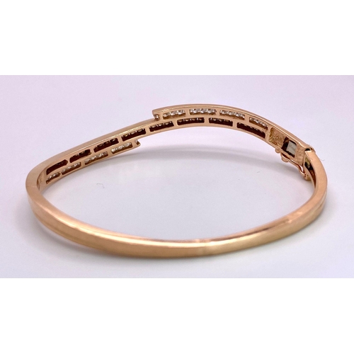 959 - A 14K Rose Gold, White and Cognac Brown Diamond Wave Bangle. Over 60 round cut diamonds ride on a wa... 