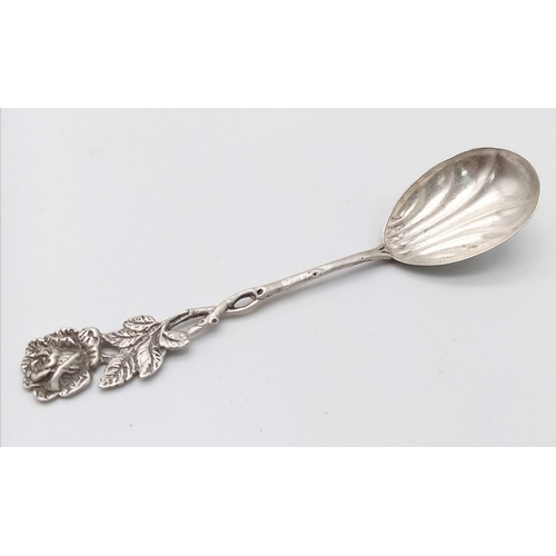 1088 - An antique silver spoon.
A rose designed handle which flows down to a clam-shell like spoon bowl. St... 