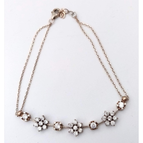 1281 - A 925 Silver Bracelet a gemmed flower motif accents.
Length: 18cm
Weight: 3.47g