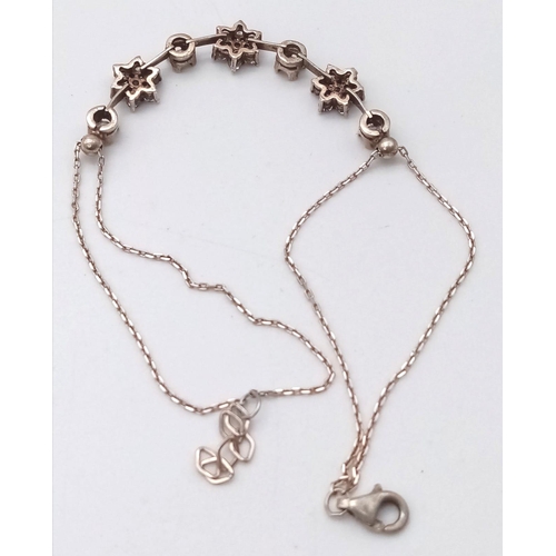 1281 - A 925 Silver Bracelet a gemmed flower motif accents.
Length: 18cm
Weight: 3.47g