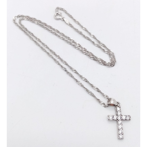 1295 - A 925 Silver necklace with a gemmed Crucifix.
Measures 44cm in length
Weight: 2.86g