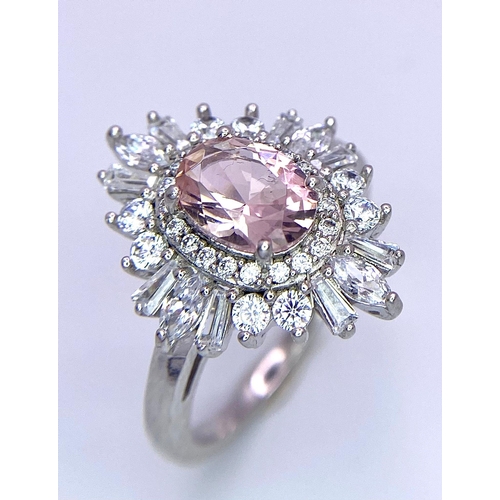 1389 - A 925 Silver Ring, with central pink stone. 
Framed beautifully by a halo of various sized white sto... 