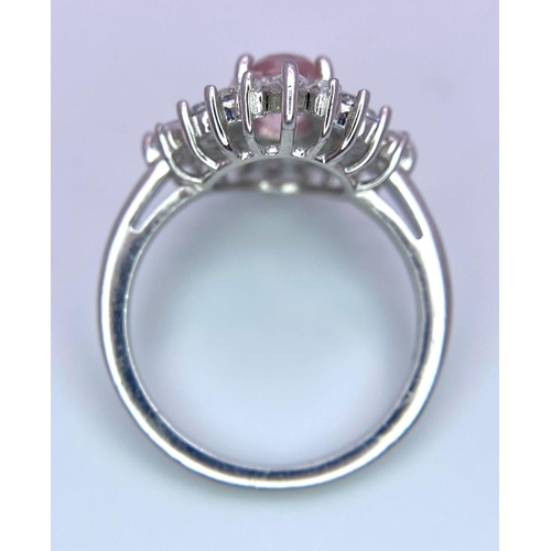 1389 - A 925 Silver Ring, with central pink stone. 
Framed beautifully by a halo of various sized white sto... 