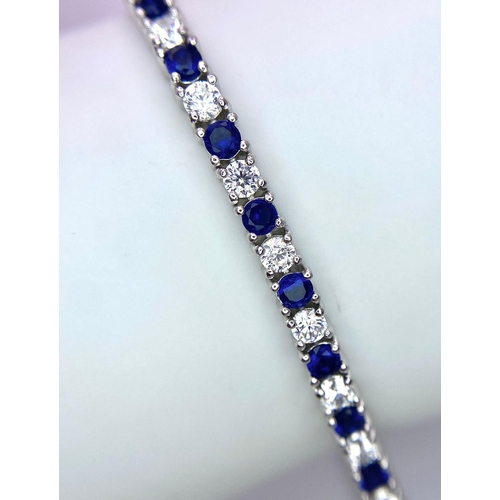 947 - A 925 Silver, Blue & White Stone Tennis Bracelet.
Measures 20cm in length.
Weight: 12.5g