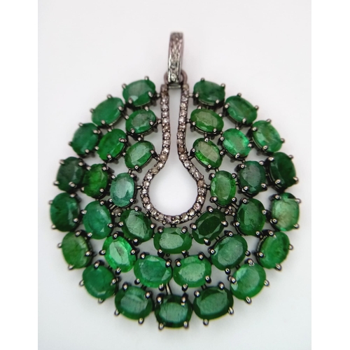 1260 - A striking Emerald & Diamond, Sterling Silver Pendant.
17.9cts of luminous Emerald stones with a cen... 