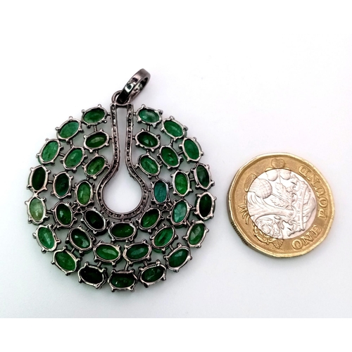 1260 - A striking Emerald & Diamond, Sterling Silver Pendant.
17.9cts of luminous Emerald stones with a cen... 