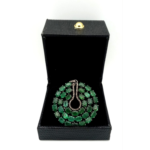 1260 - A striking Emerald & Diamond, Sterling Silver Pendant.
17.9cts of luminous Emerald stones with a cen... 