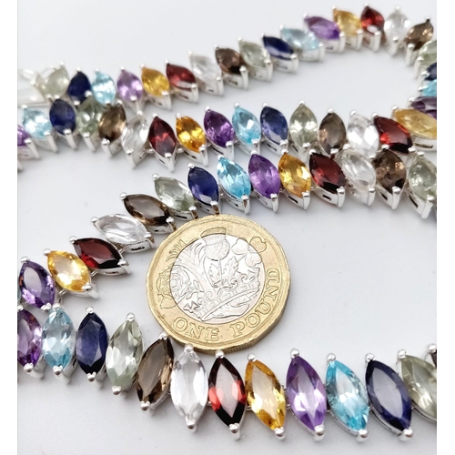 1267 - A dazzling Marquise Cut Gemstone Tennis Necklace set in 925 Silver. Featuring a wide variety of gems... 