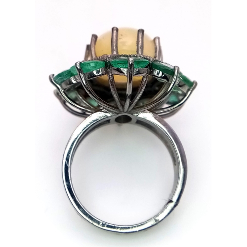 1274 - An exquisite, Opal, Emerald & Diamond, Sterling Silver Ring.
The central 6.10ct Opal has a halo of 0... 