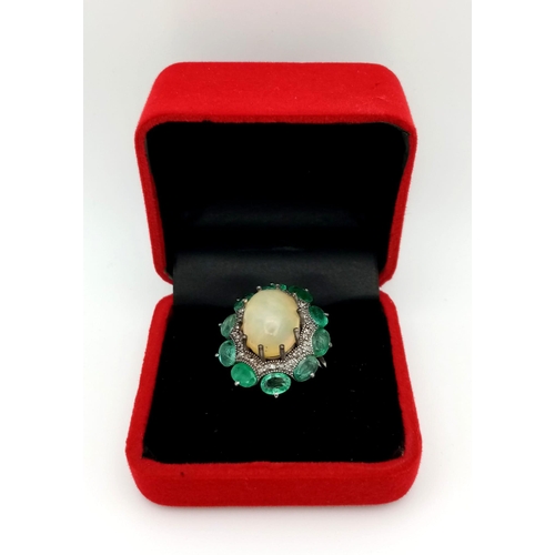 1274 - An exquisite, Opal, Emerald & Diamond, Sterling Silver Ring.
The central 6.10ct Opal has a halo of 0... 