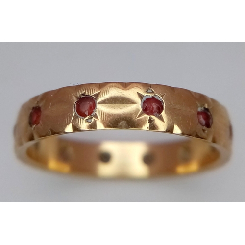 1414 - A Vintage 9K Yellow Gold Garnet Eternity Ring. Size M. 2.1g total weight.