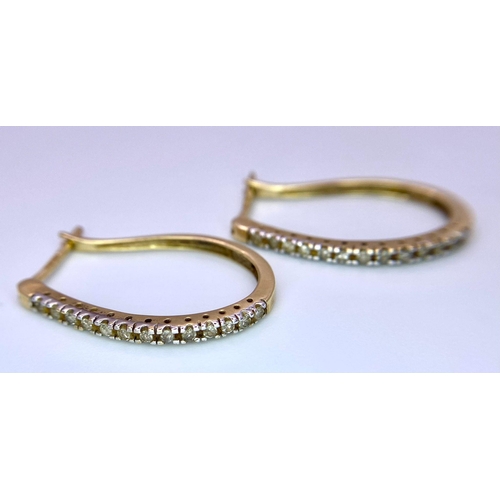 1493 - A Pair of 9K Yellow Gold and Diamond Elongated Hoop Earrings. 2.33g total weight.