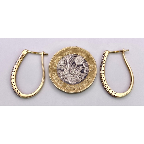 1493 - A Pair of 9K Yellow Gold and Diamond Elongated Hoop Earrings. 2.33g total weight.