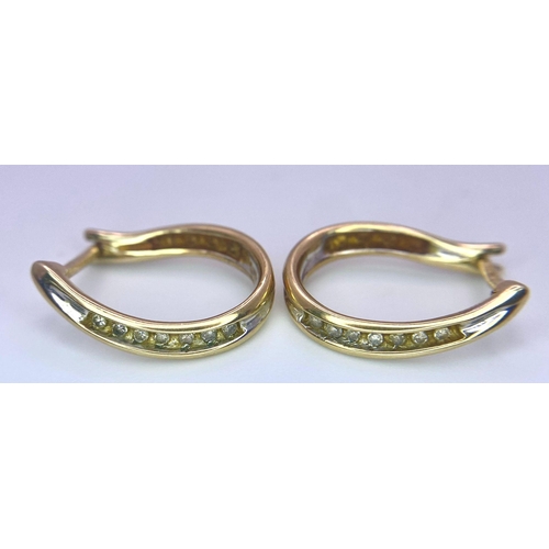 1663 - A Pair of 9K Yellow Gold and Diamond 'Lucky Horse-Shoe' Earrings. 2.34g total weight.