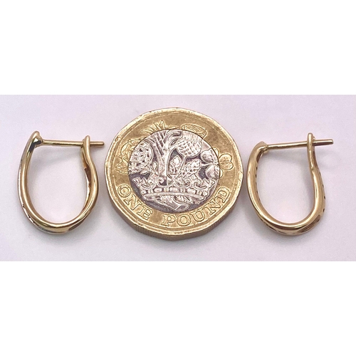 1663 - A Pair of 9K Yellow Gold and Diamond 'Lucky Horse-Shoe' Earrings. 2.34g total weight.